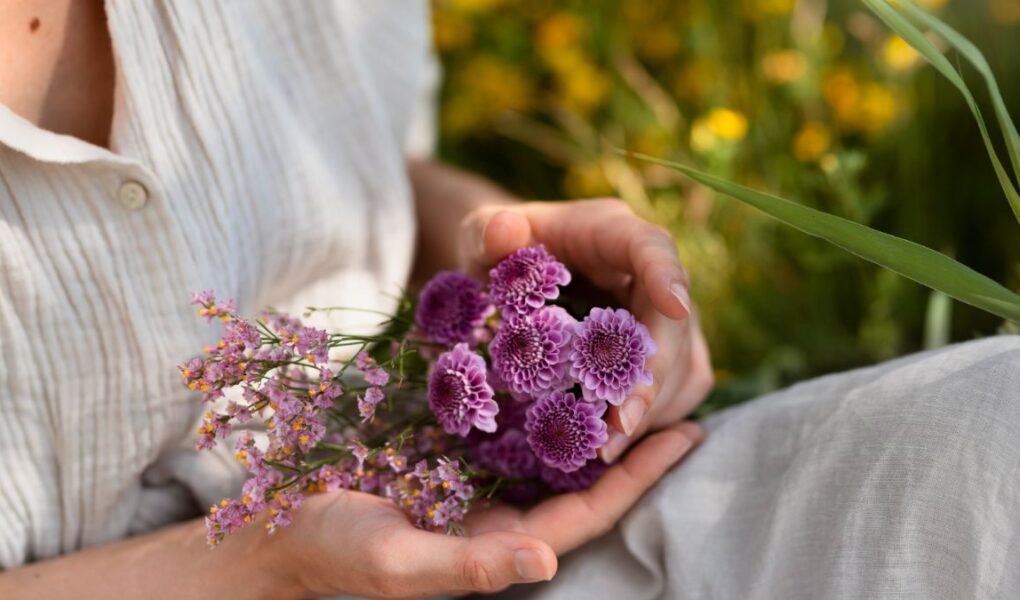 mulher segurando flores para representar o uso dos florais